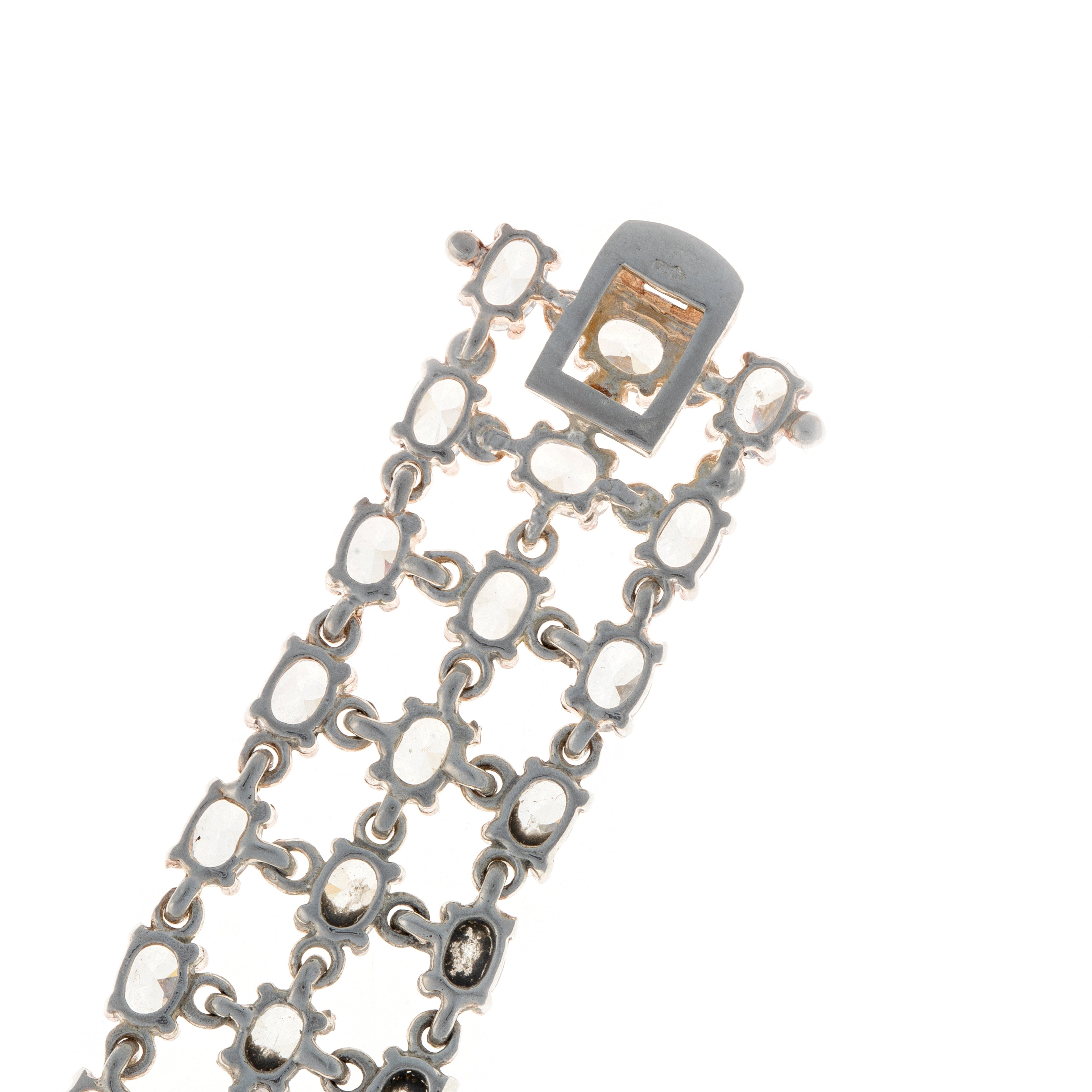 Close-up of bracelet clasp back side and end link details on sterling silver tennis bracelet with zircon stones.