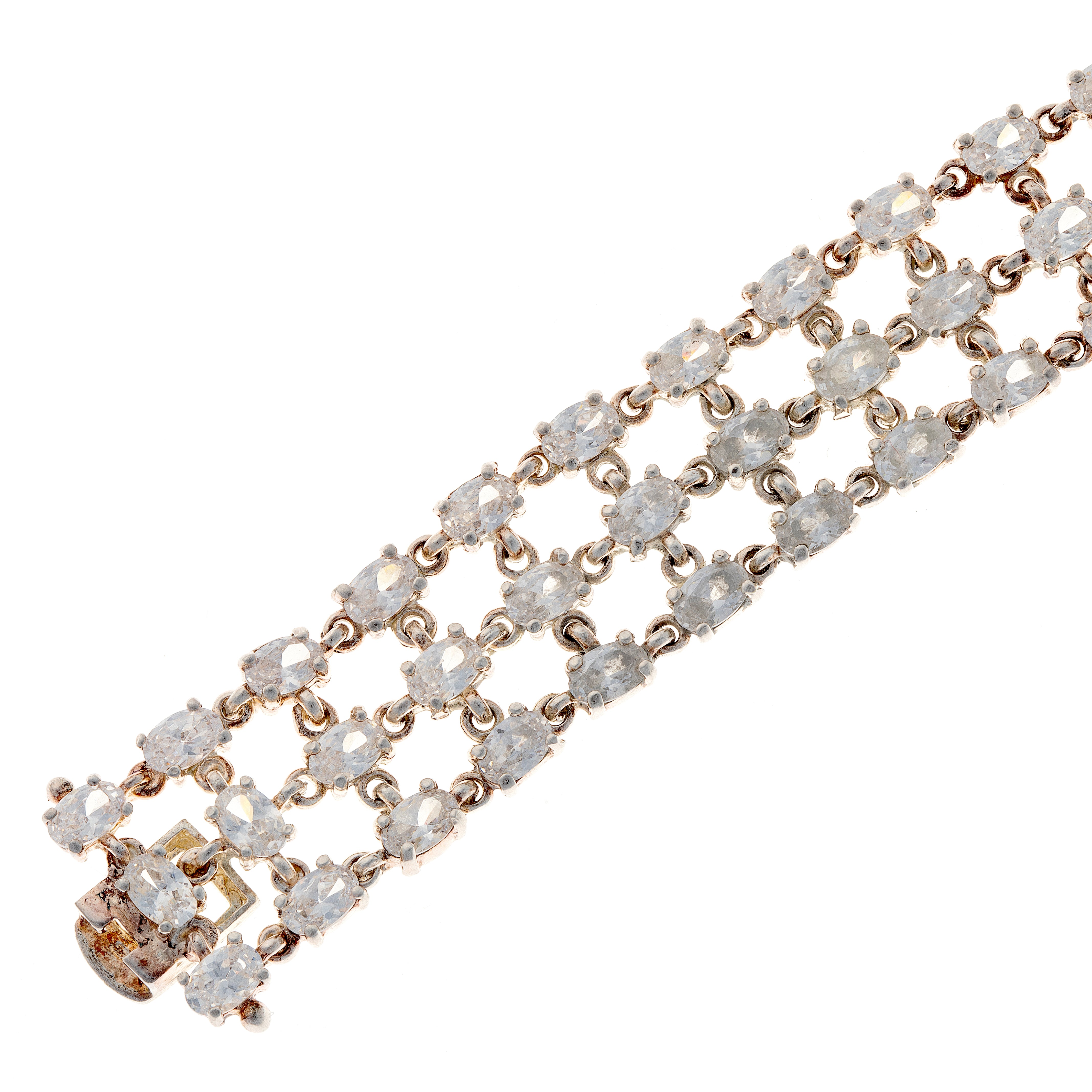 Detail image showing claw-set oval zircons and lattice structure of three-row sterling silver bracelet.