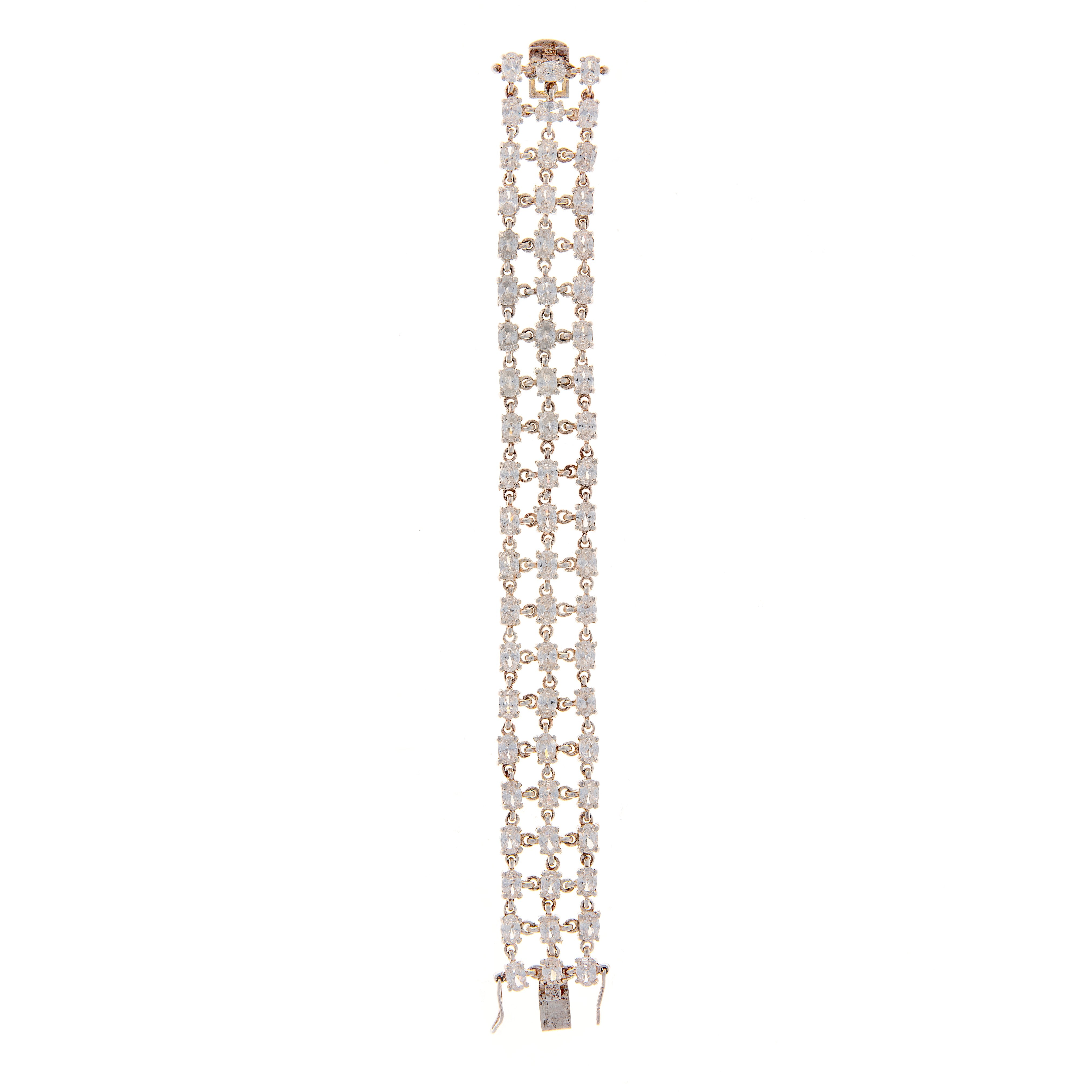 Extended vintage sterling silver bracelet with three symmetrical zircon rows and articulated links.