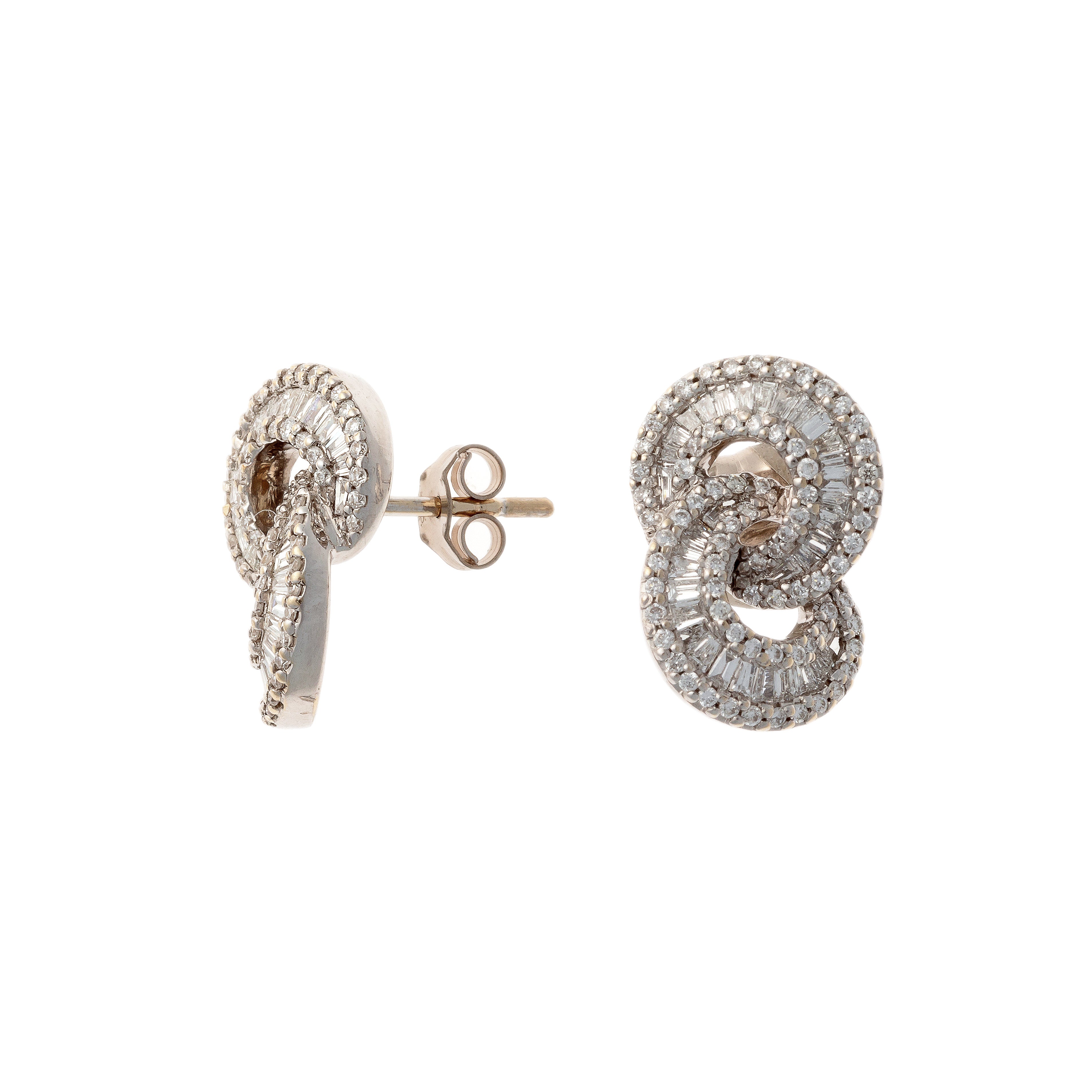 Angled view of the pair of vintage white gold earrings with baguette and round diamonds.