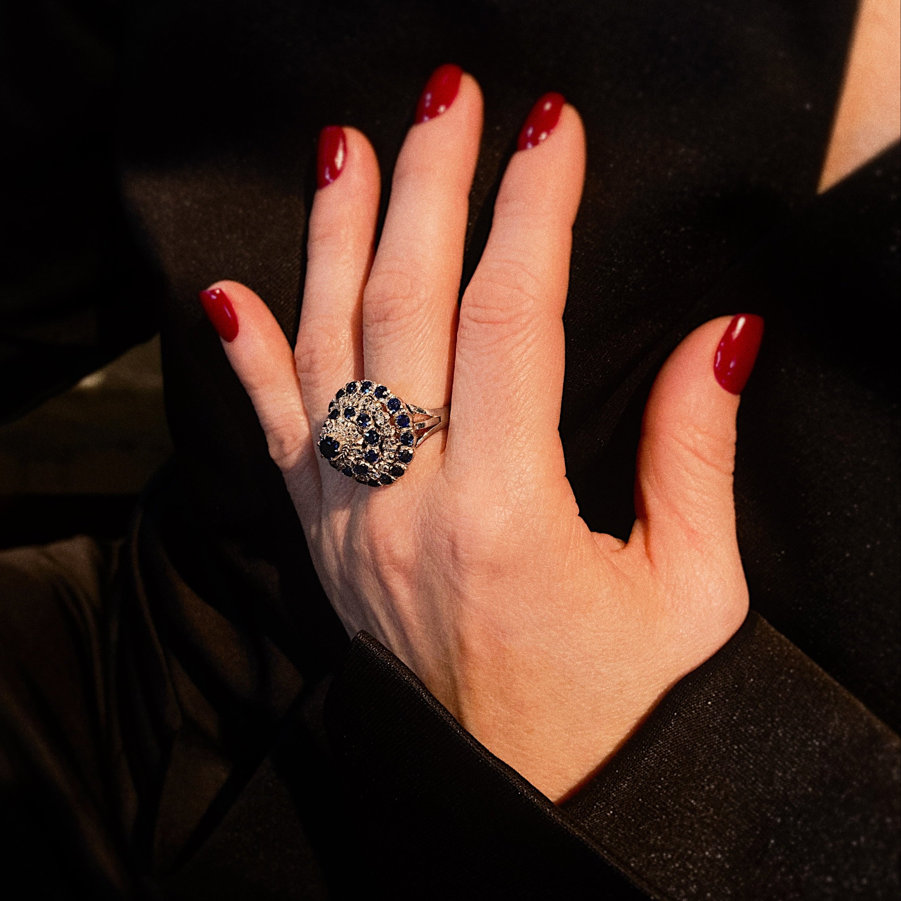 Model wearing the vintage white gold cocktail ring with sapphires and diamonds.