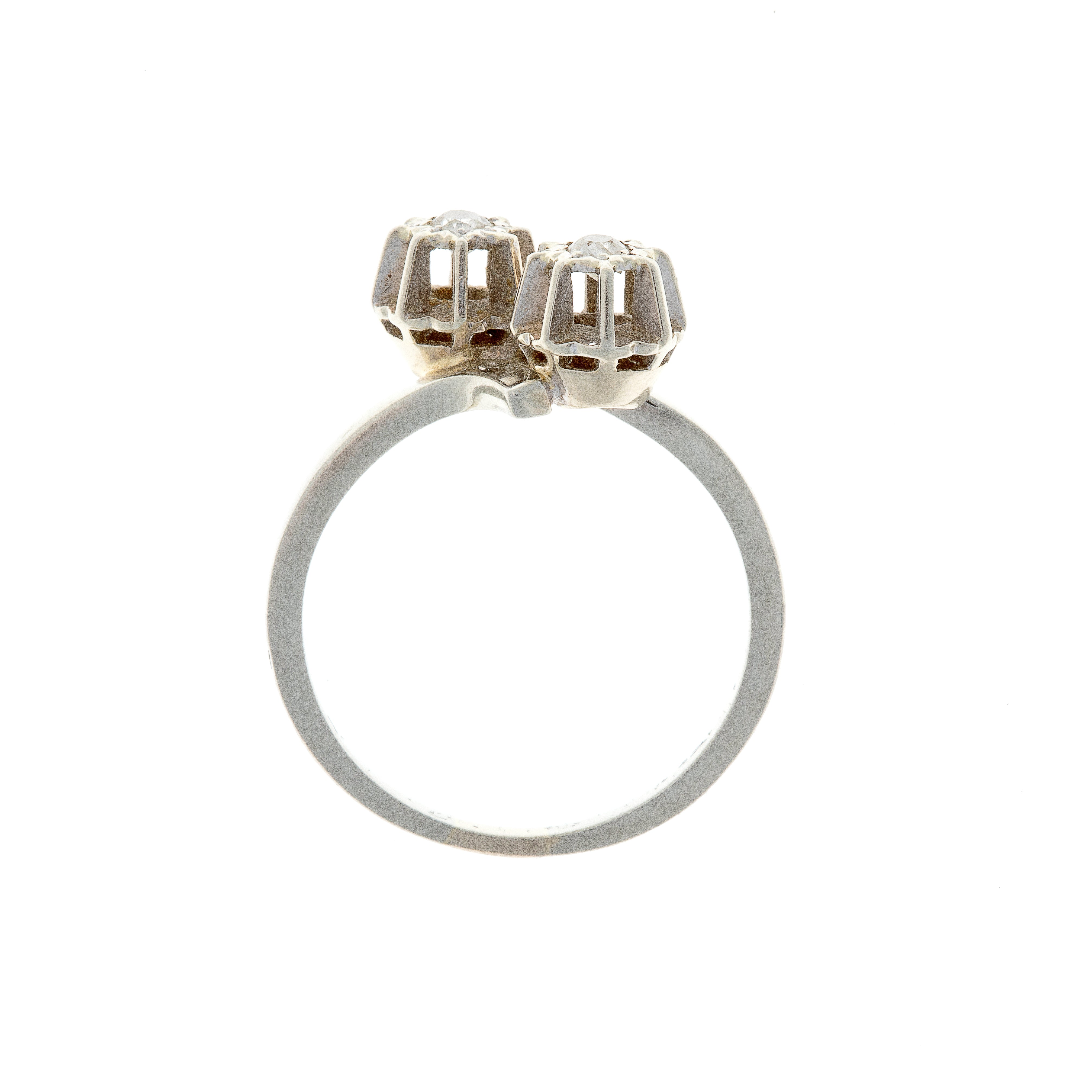 Profile of contemporary Belgian toi et moi ring with raised diamond cluster settings.