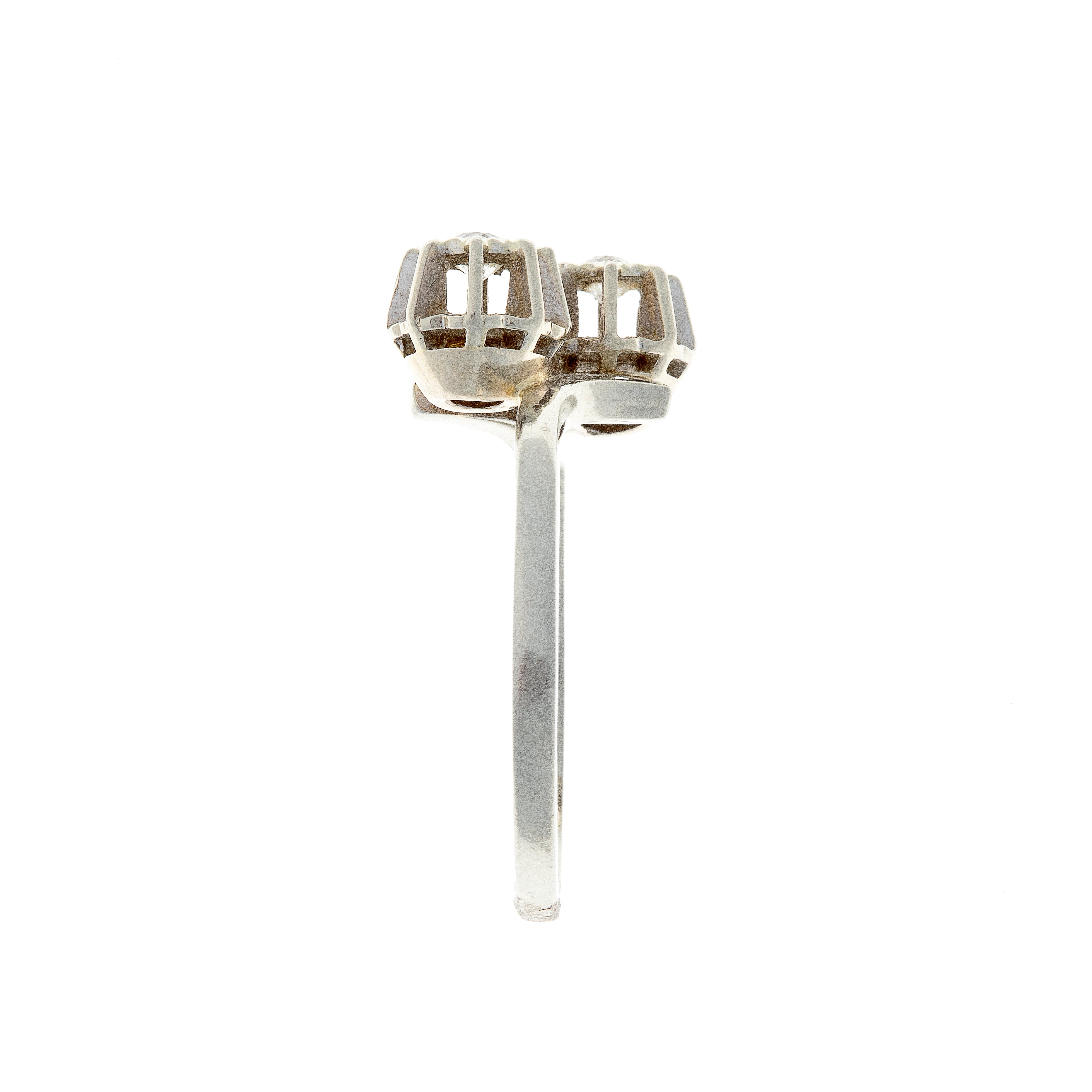 Side view of 18K white gold ring showing parallel twin diamond settings on a sleek band.