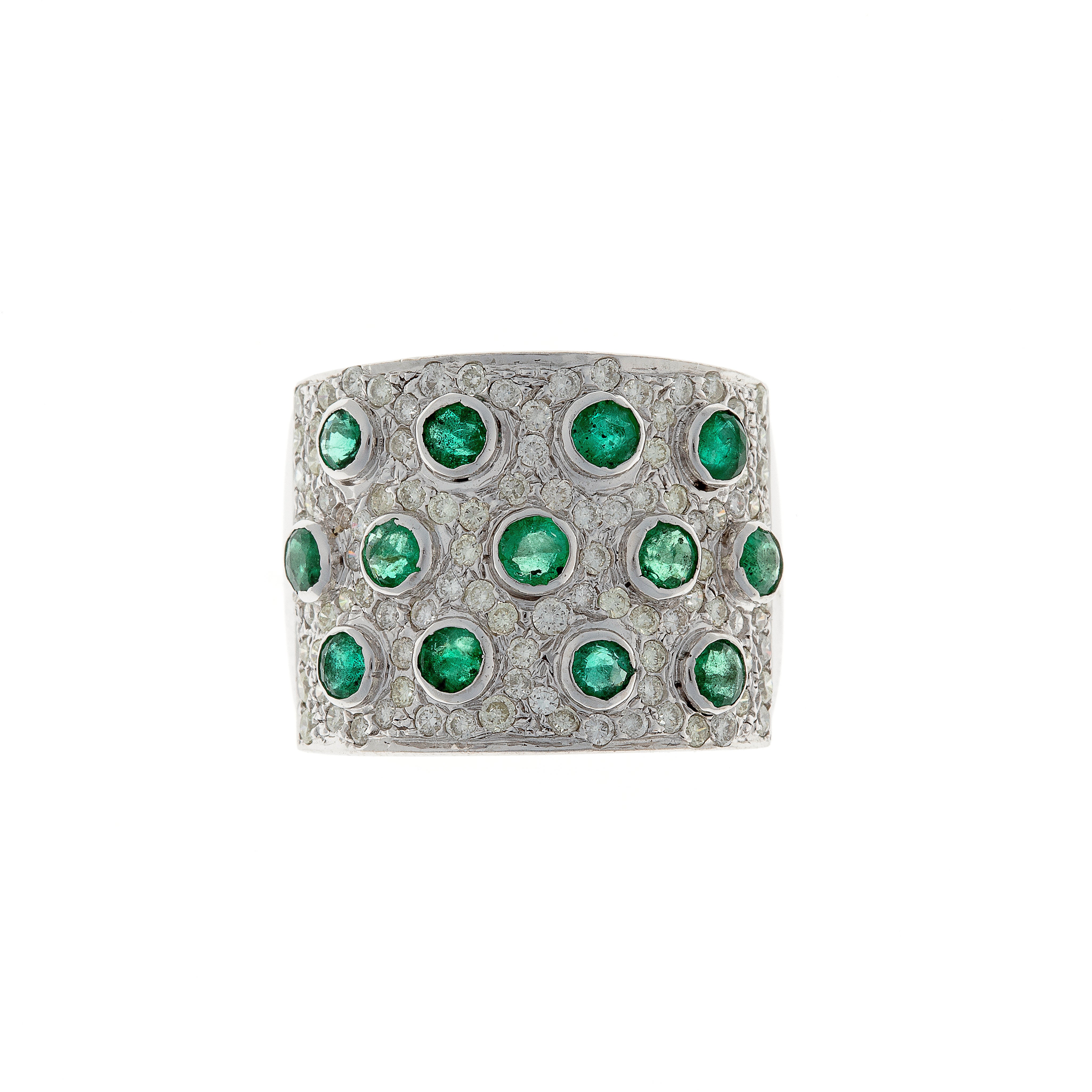 Vintage bold white gold statement ring featuring vibrant emeralds and pavé-set diamonds in a wide band design.