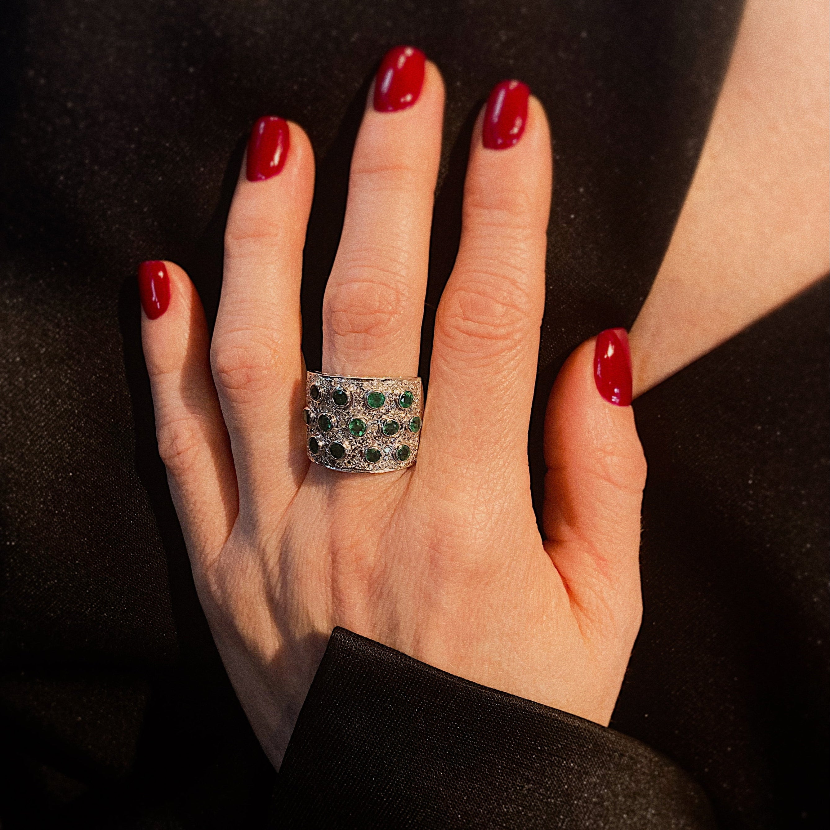 Model wearing the vintage white gold cocktail statement ring with emeralds and diamonds.