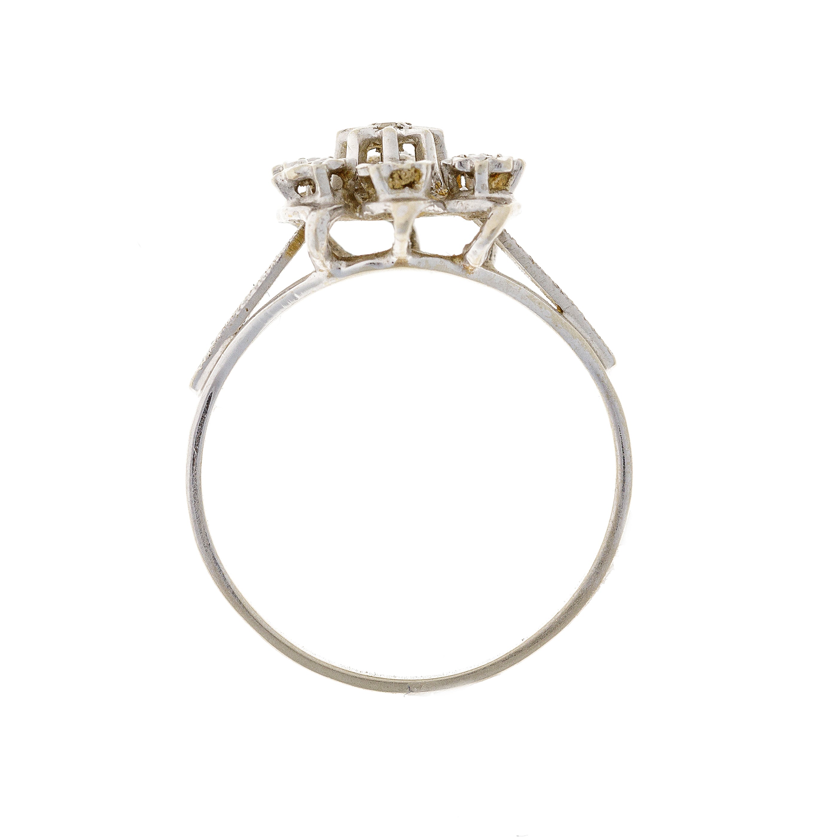 Front view of the vintage diamond floral ring, displaying the symmetrical setting of seven diamonds in a nature-inspired arrangement.