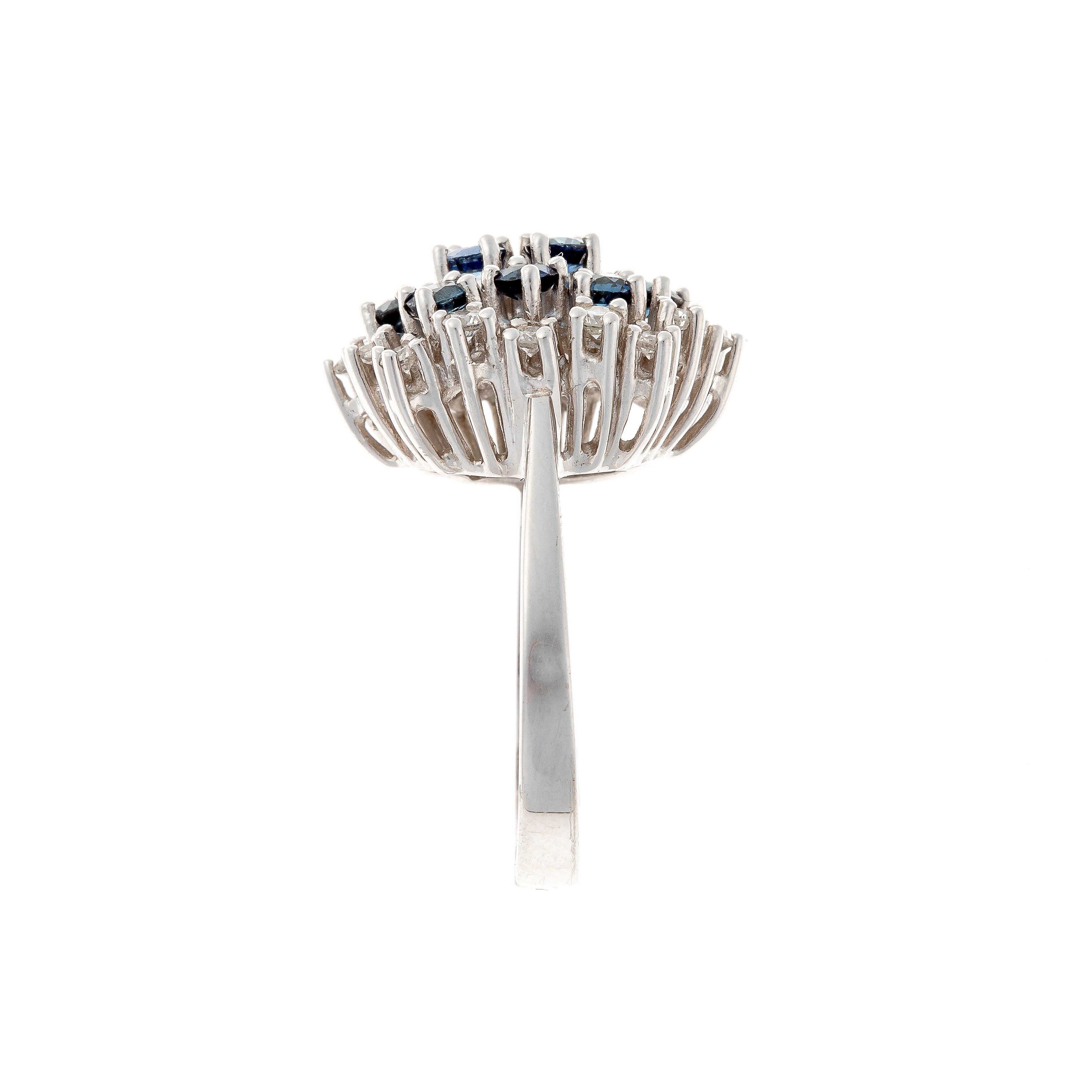 Side view of the contemporary vintage white gold cluster cocktail ring with blue sapphires and diamonds.