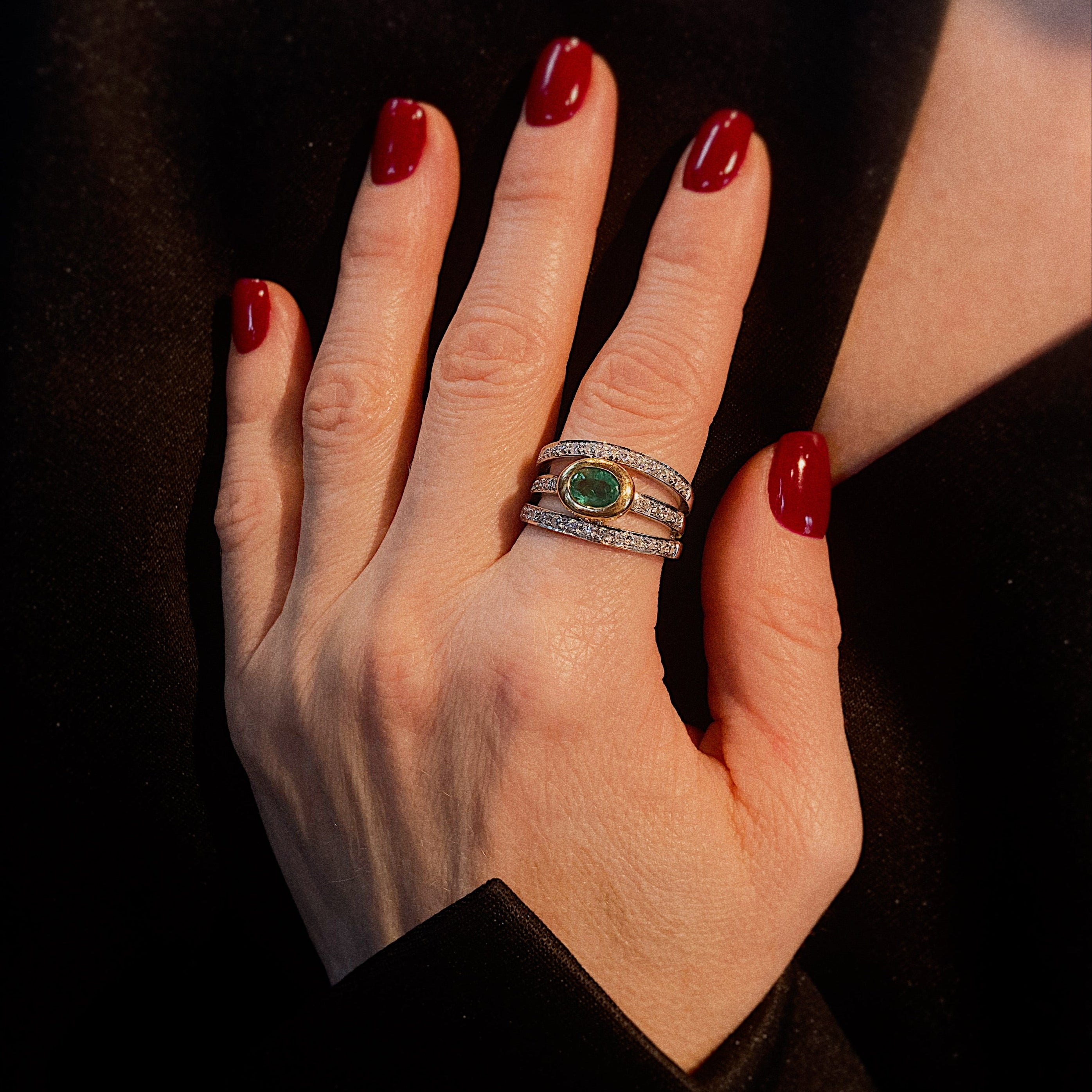 Model wearing the vintage white and yellow gold emerald and diamond cocktail ring.