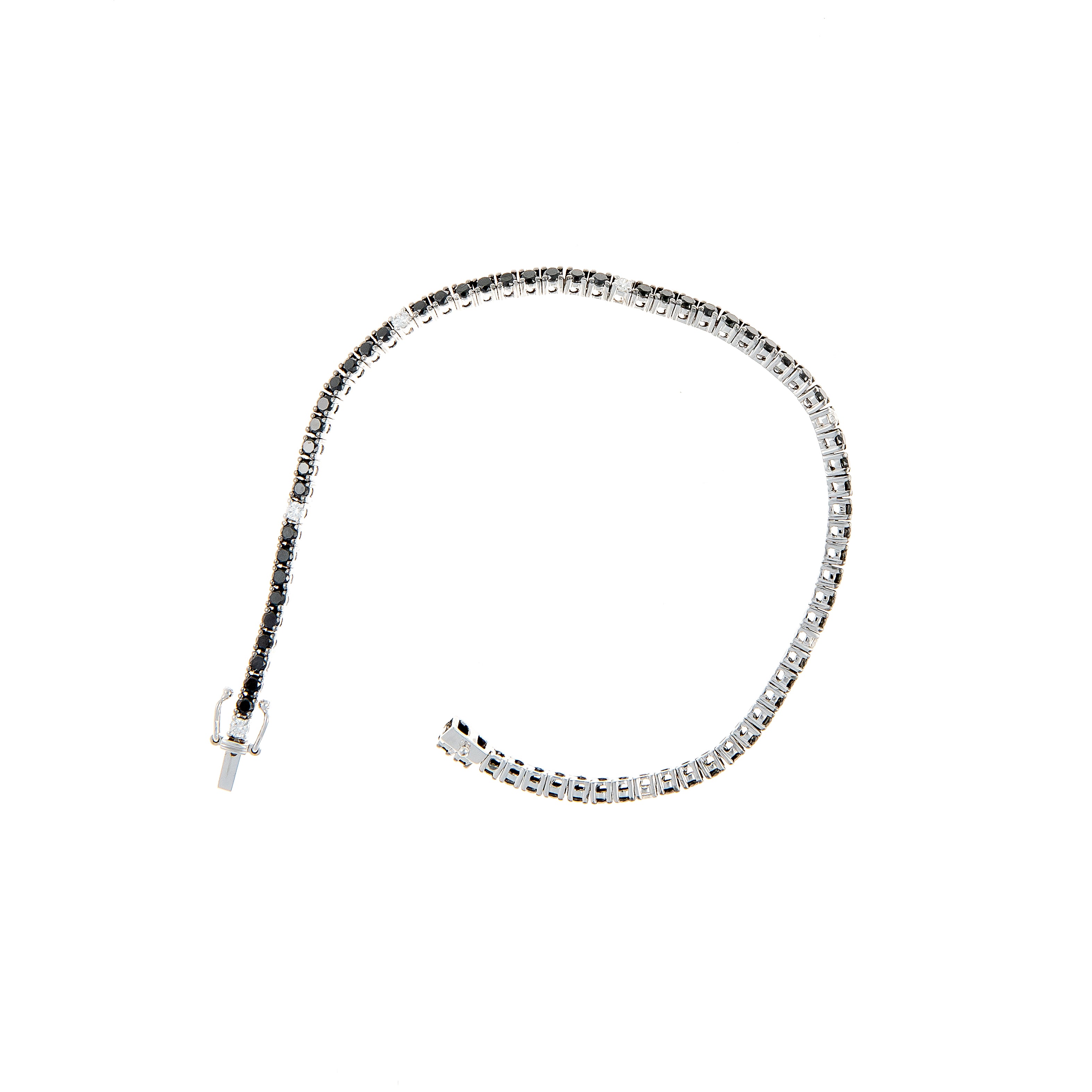 Side angle of a white gold tennis bracelet showcasing black diamonds with white diamond accents.