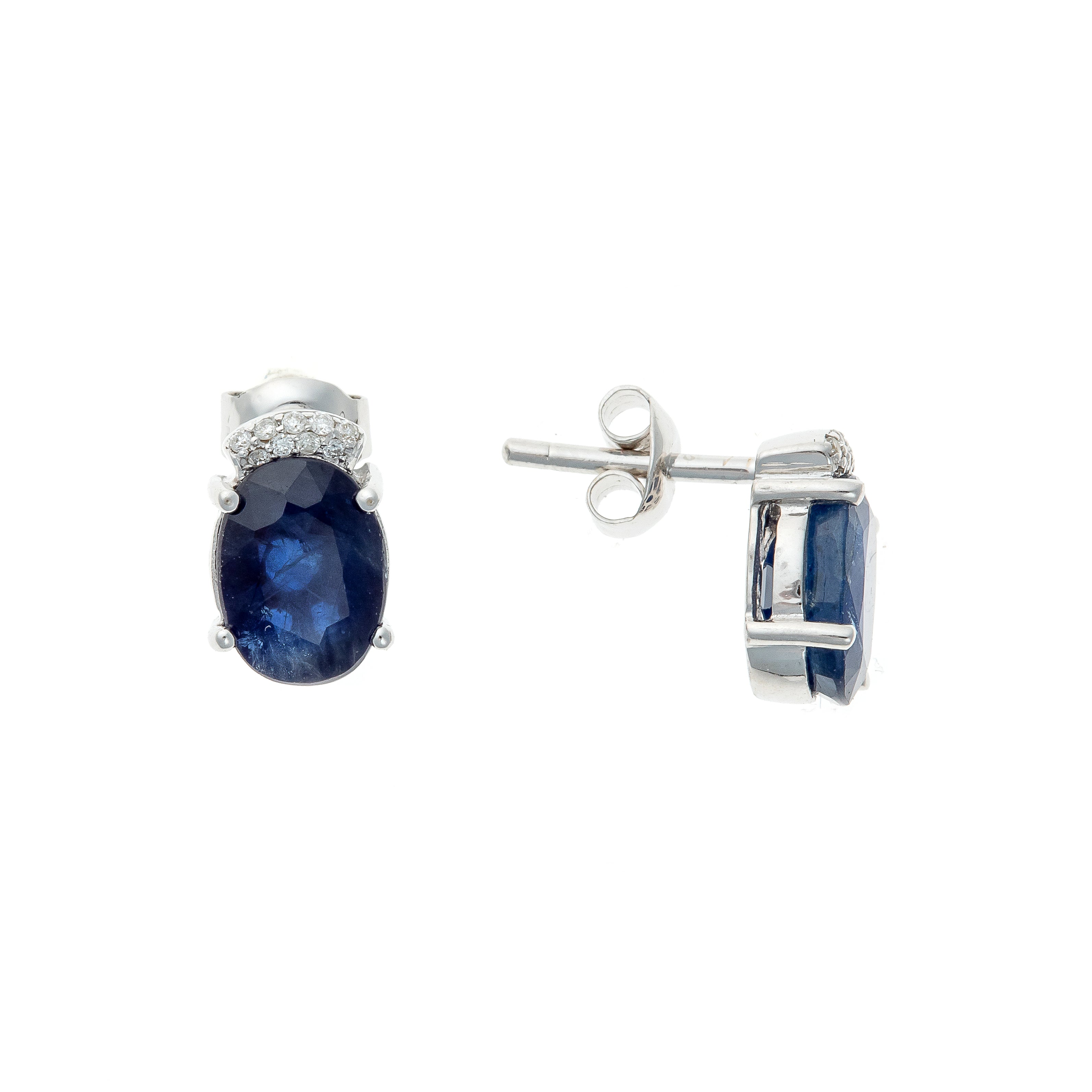 Side view of the stud earrings, highlighting the deep blue sapphires and white gold setting.